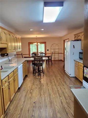 A well-appointed kitchen flows seamlessly into a dining area, offering a functional and inviting living space.