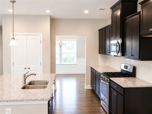 The dining room connects to the kitchen via a cased opening, and the pantry is conveniently located between the two rooms.