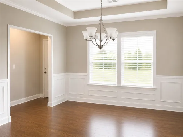 Positioned at the front of the home, the dining room offers an inviting setting for gatherings and meals.
