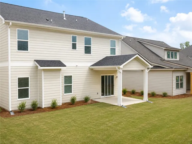 A covered back porch and spacious lawn make for great outdoor living.