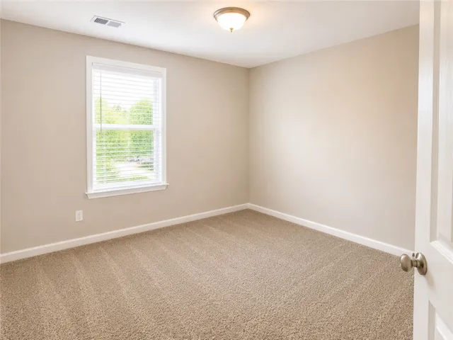 All bedrooms feature a neutral paint color and carpet.