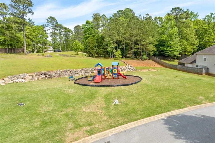 A vibrant playground set amidst a verdant landscape provides recreation for all ages.
