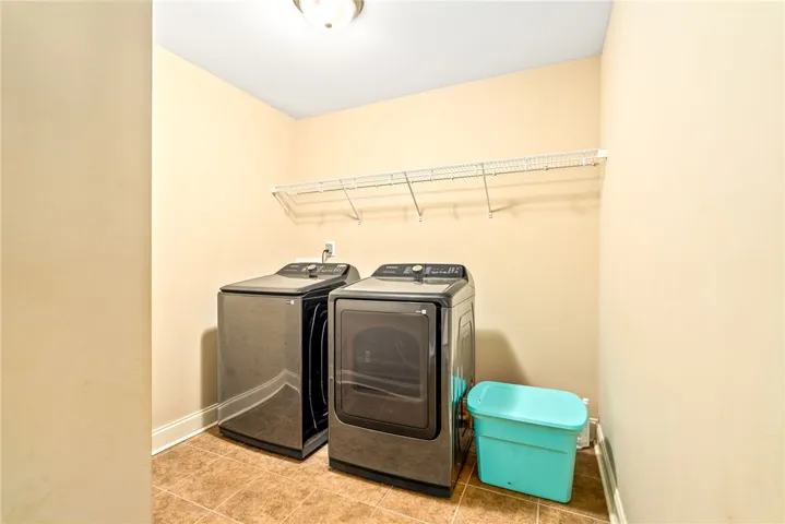 Functional laundry space featuring modern appliances and practical wire shelving for organization.