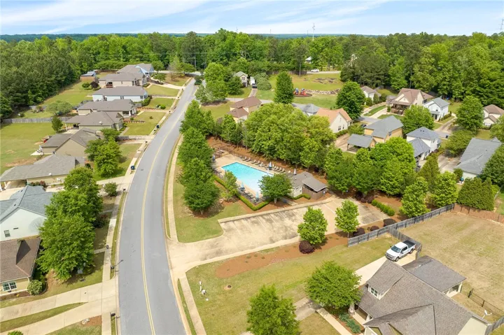 An aerial perspective reveals a vibrant community complete with a sparkling pool and a playground.