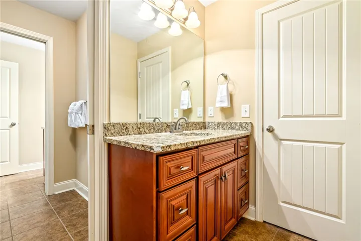 A well-appointed bathroom vanity with granite counters and ample storage, providing both utility and elegance.