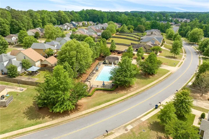 An inviting community pool with lush landscaping, offering a refreshing escape for residents.