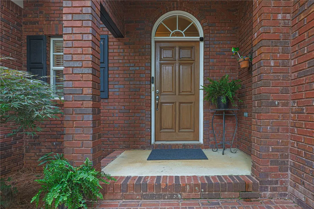A classic brick exterior offers enduring appeal to this welcoming entry.