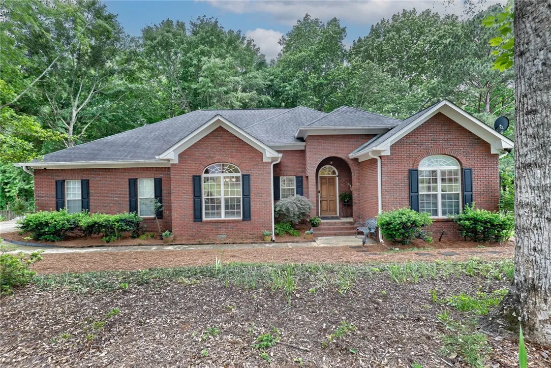 A classic brick exterior offers enduring appeal with traditional shutters and arched entryways.