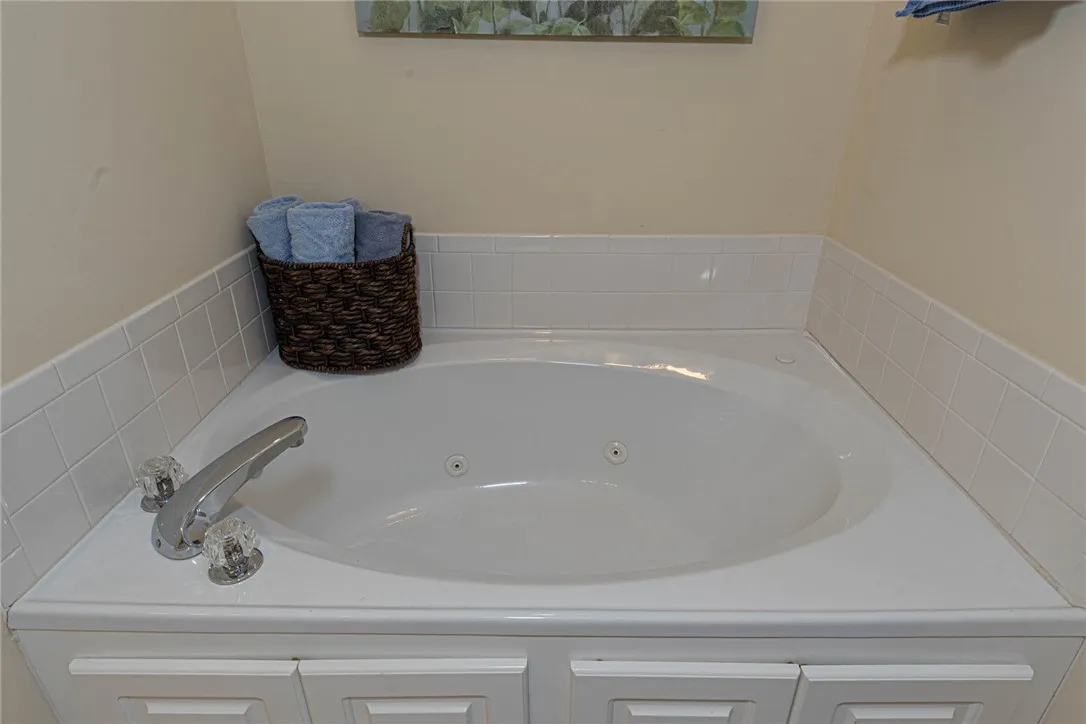 An inviting soaking tub awaits for ultimate relaxation and comfort.