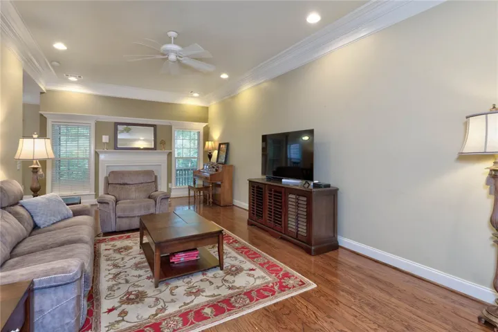 Hardwood floors and generous crown molding define this welcoming living space.