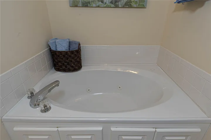 An inviting soaking tub awaits for ultimate relaxation and comfort.