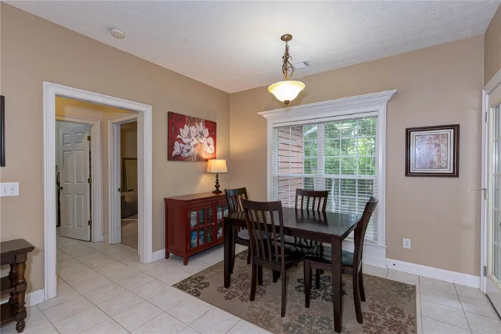 A welcoming dining area offers ample space for meals and overlooks natural outdoor scenery.