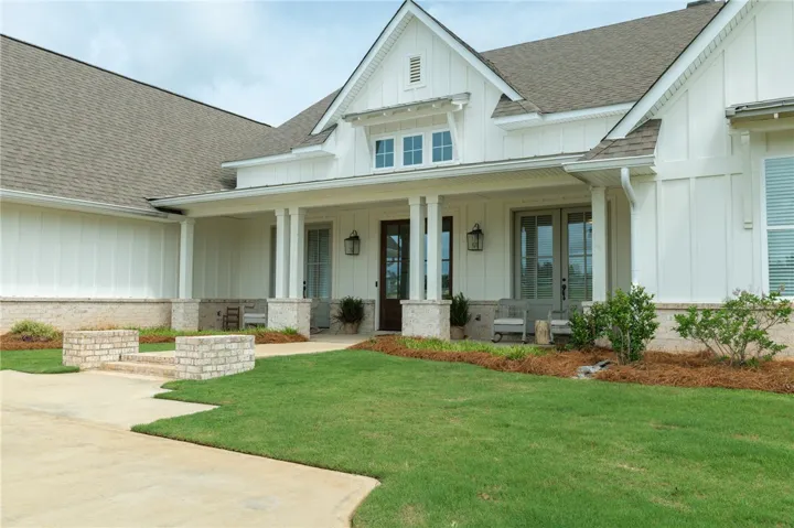A welcoming façade with a covered front porch and classic architectural elements offers superb curb appeal.