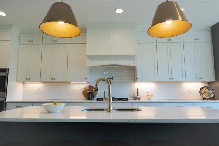 A well-lit culinary space features bright overhead lighting and practical under-cabinet illumination.