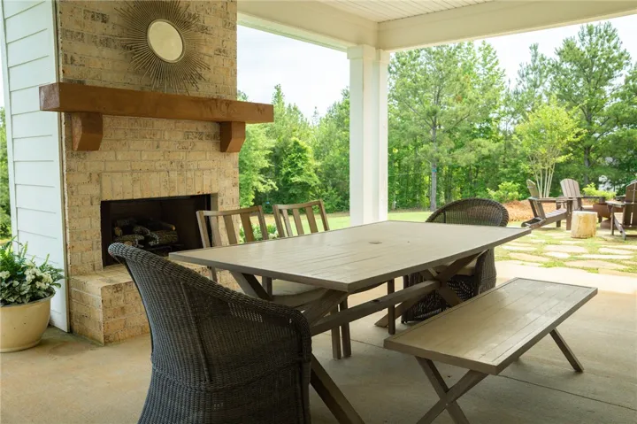 An inviting outdoor living area features a brick fireplace, providing warmth and ambiance.