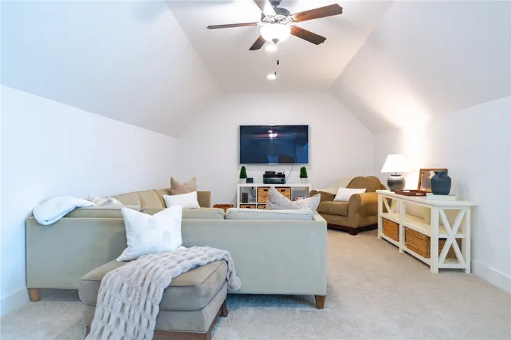 Sloping ceilings create an intimate, cozy atmosphere in this versatile bonus room.