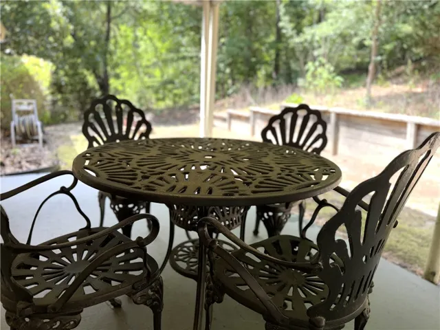 Enjoy tranquil outdoor living on this inviting patio, offering a serene view of surrounding greenery.