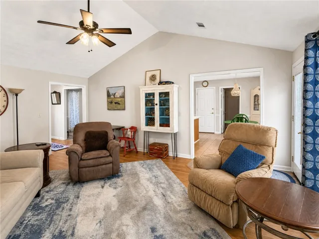 The generously sized living area boasts high vaulted ceilings, offering an open and airy atmosphere.