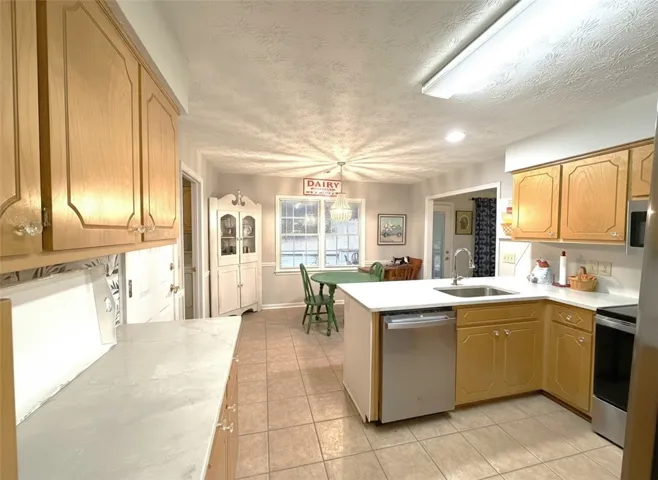 A well-appointed kitchen showcasing light wood cabinetry and a functional central island.