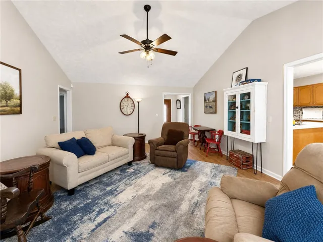 A comfortable living space boasts a high vaulted ceiling, creating an open and airy atmosphere.