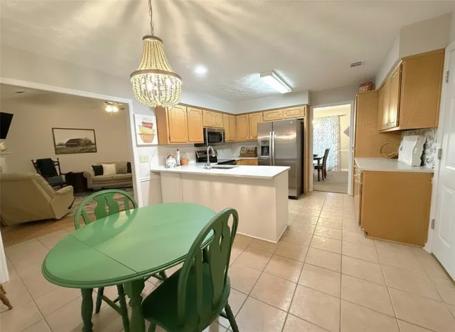 A well-appointed kitchen with an eat-in island flows seamlessly into the adjacent living space.