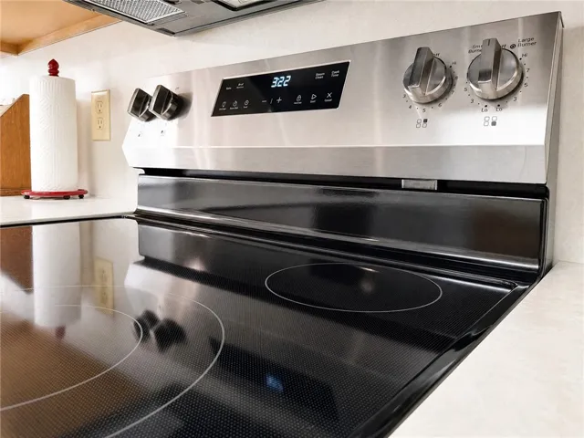 A sleek electric range with stainless steel finishes elevates this functional kitchen.