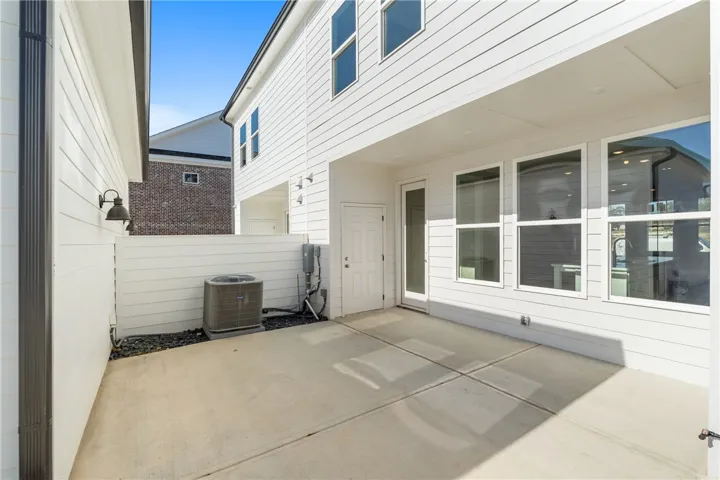 A private, paved patio space offers seamless outdoor living, ideal for relaxation or entertaining. Photos are not of subject property. Photos are of the same floorplan of a completed home.