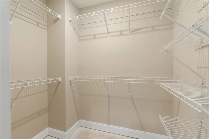 Ample wire shelving provides generous storage space in this organized walk-in closet. Photos are not of subject property. Photos are of the same floorplan of a completed home.