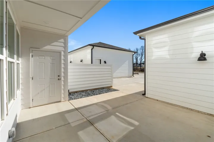 Clean lines define this home's modern exterior with a private patio space. Photos are not of subject property. Photos are of the same floorplan of a completed home.