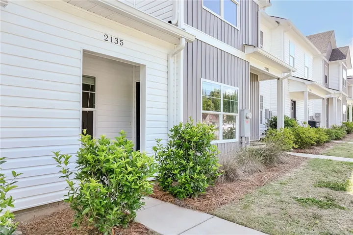 Clean lines and modern siding create an inviting entrance to this community of townhomes.