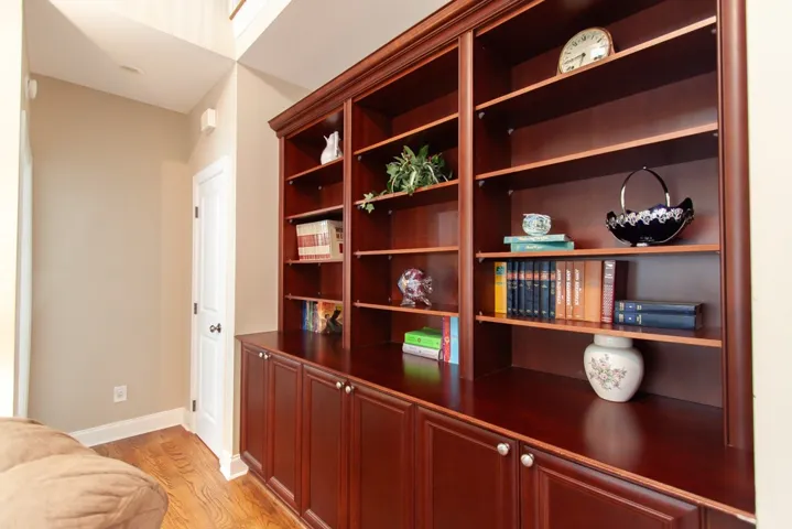 Custom built-in shelving with base cabinetry provides ample storage and display space.