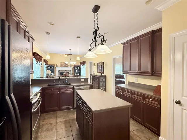 A functional kitchen boasts rich cabinetry and an inviting open concept connecting to the living area.