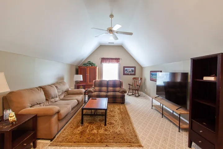 Sloped ceilings and a neutral color palette create a cozy and inviting atmosphere in this versatile bonus room.