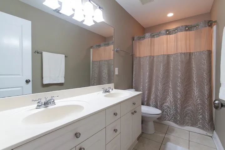 Double vanity and modern fixtures create a refreshing and functional bathroom space.
