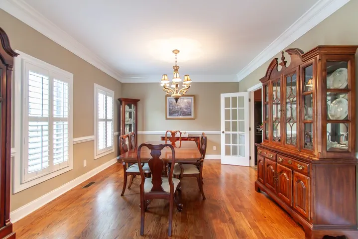 Hardwood floors and crown molding elevate this welcoming dining room.