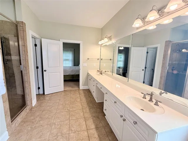 Dual vanities and a spacious shower elevate this primary bathroom's allure.