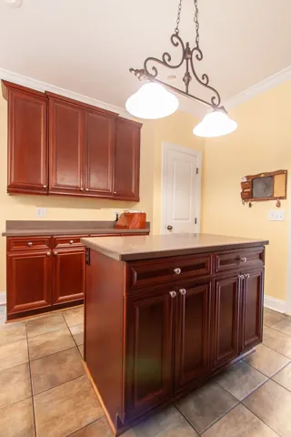 Rich wood cabinetry and a central island define this well-appointed kitchen space.
