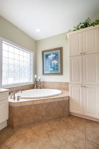 Luxurious soaking tub set against an elegant tiled surround.