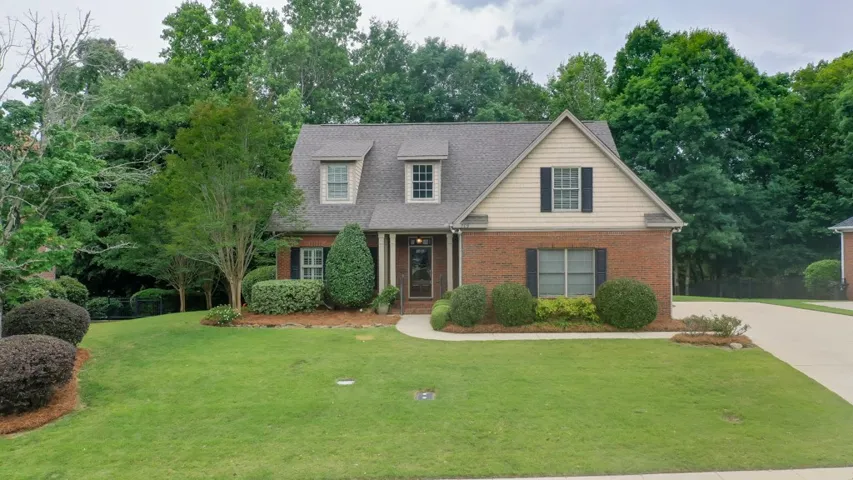 A well-maintained brick and siding facade with mature landscaping provides charming curb appeal.