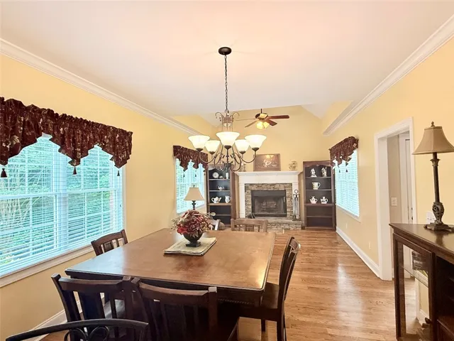 Hardwood floors and a charming fireplace anchor this inviting dining area.