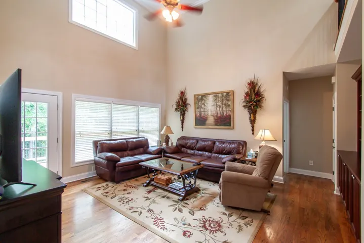 Main Living room.  Natural light floods this living space, highlighting vaulted ceilings and warm wood flooring.