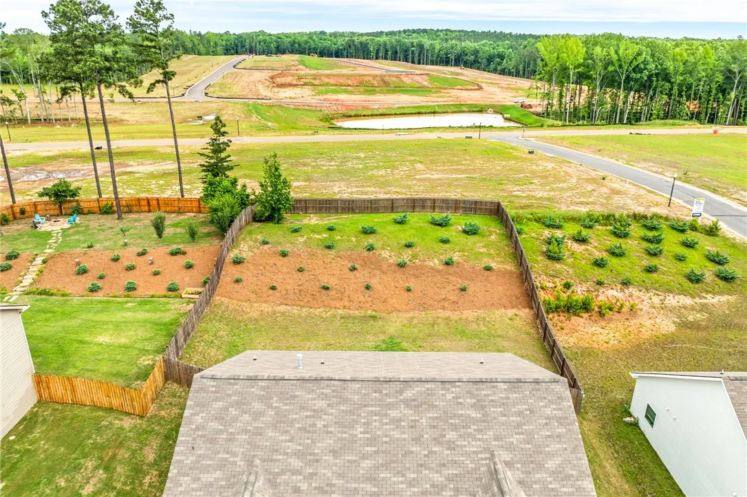 View the developing landscape with a tranquil pond and surrounding woodlands, ideal for a new build.