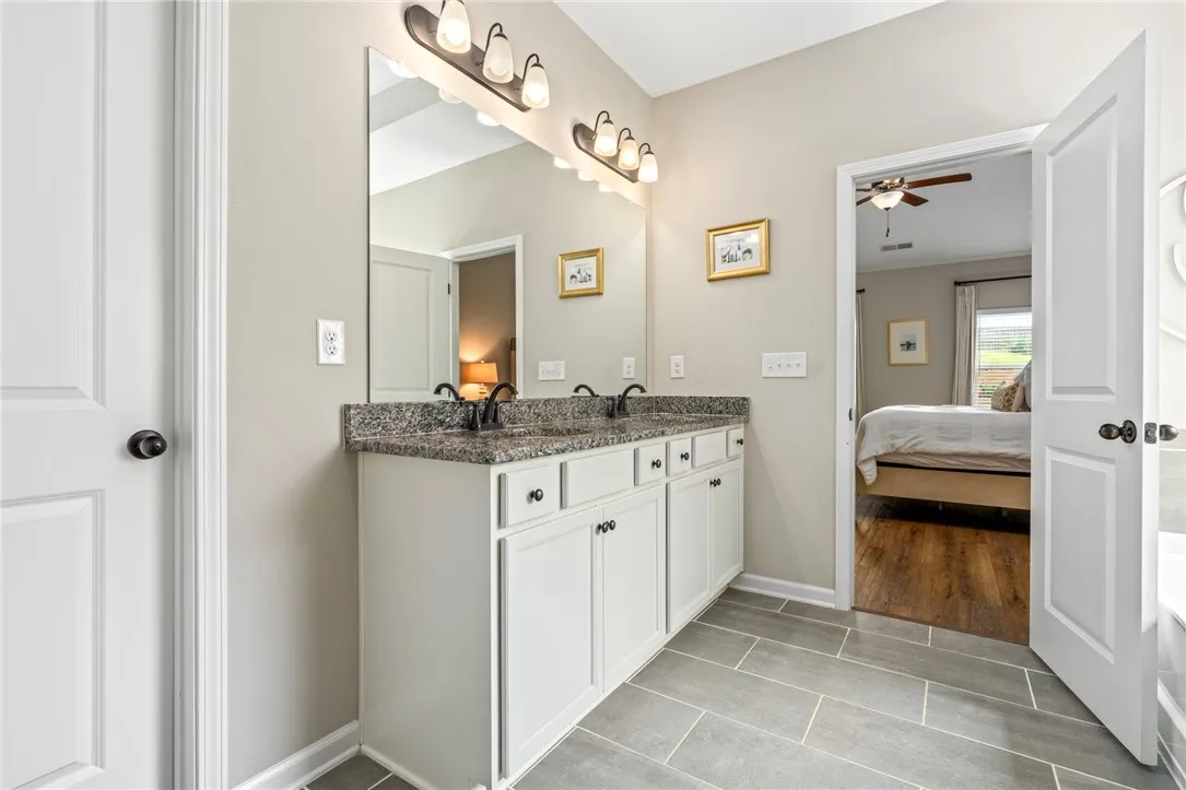 A well-appointed bath features a spacious dual vanity with ample storage.
