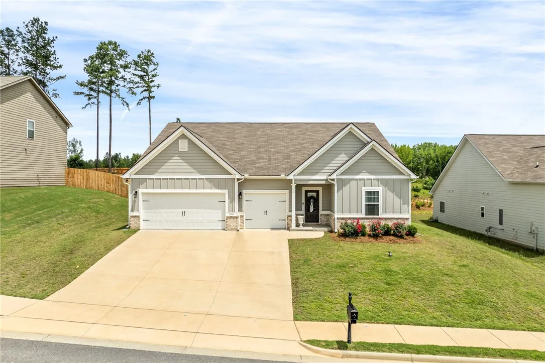 A well-maintained lawn and extended driveway welcome residents to this charming dwelling.