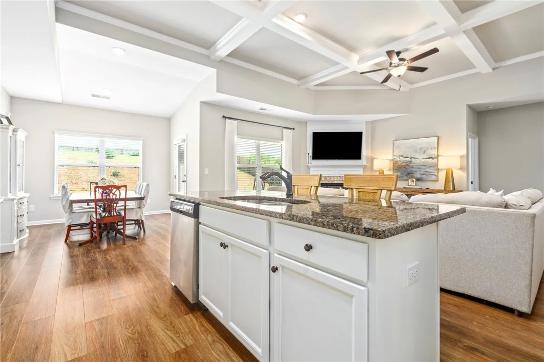 A well-lit open-concept living space connects a gourmet kitchen, dining area, and welcoming family room.