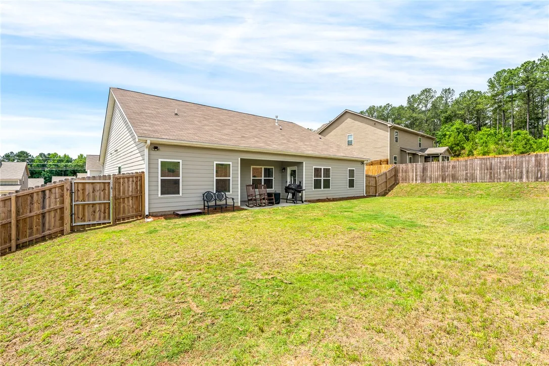 A spacious backyard with privacy fencing, ideal for outdoor entertaining and relaxation.
