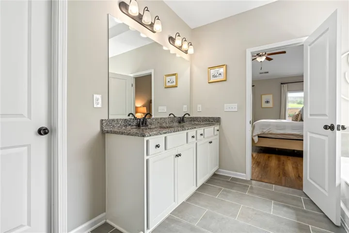 A well-appointed bath features a spacious dual vanity with ample storage.
