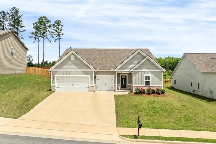 A well-maintained lawn and extended driveway welcome residents to this charming dwelling.