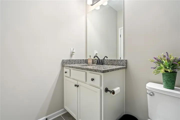 A well-appointed bathroom features a contemporary vanity and practical amenities.