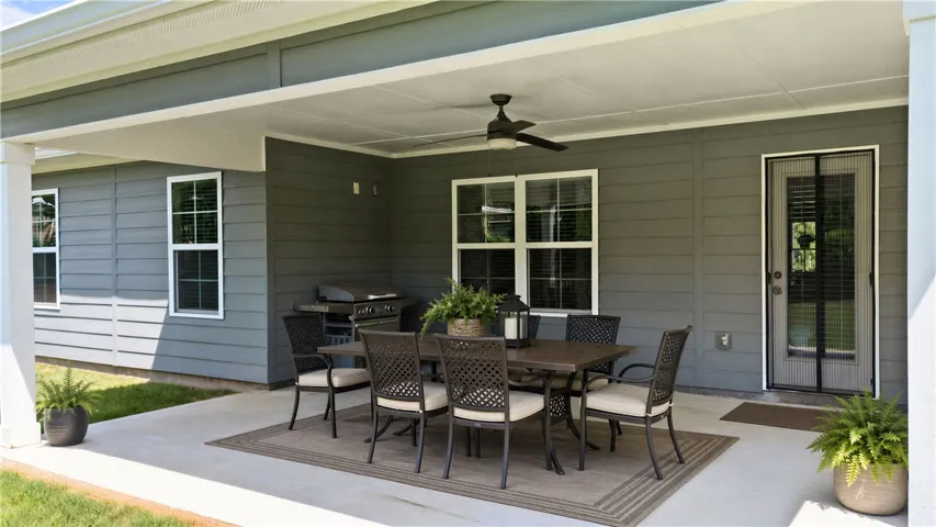 Oversized back patio overlooking a flat, fenced yard everyone wishes they had!  (Furnishings have been virtually enhanced)